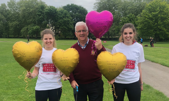 Three people with balloons