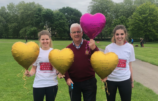 Three people with balloons